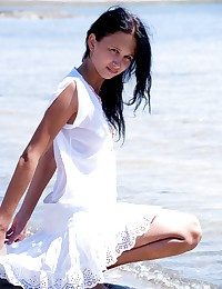 Sexy brunette teen posing bottomless on the beach
